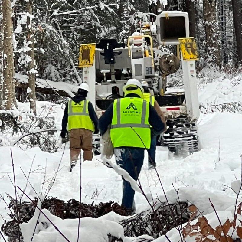 snow-storm-restoration Two Men Walking in the Snow Towards a Truck